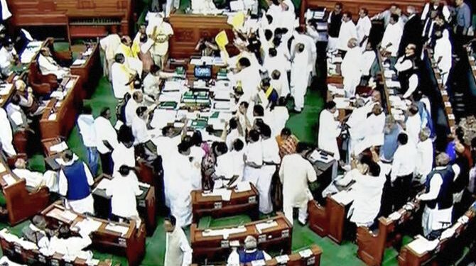 New Delhi: Opposition members protest during the ongoing budget session of Parliament at the Lok Sabha in New Delhi on Monday. PTI Photo / TV GRAB   (PTI3_5_2018_000072B)